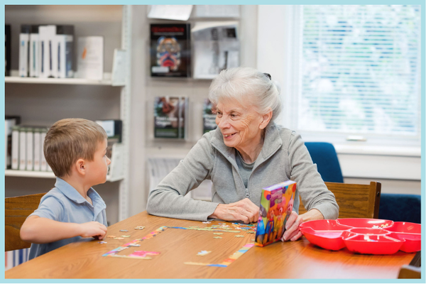 A photograph of a child and an adult working together on a puzzle.
